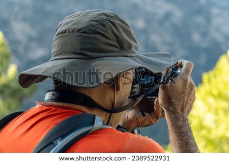 Portrait, photographer taking photos to the landscape