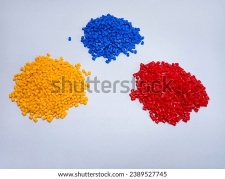 red yellow blue polymer masterbatch granules isolated on a white background suitable for catalog banner design, plastic company profile photo background