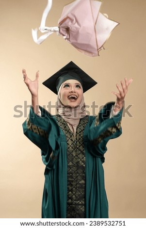 Female muslim lady smiling and posing in graduation attire