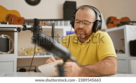 Caucasian man radio reporter working taking notes at radio studio