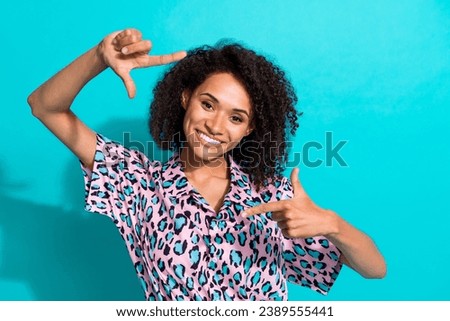 Photo of cheerful cute girl wear stylish blouse hands fingers making picture photo isolated on cyan color background