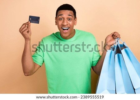 Photo portrait of attractive young man credit card shopping bags dessert food wear trendy green clothes isolated on beige color background