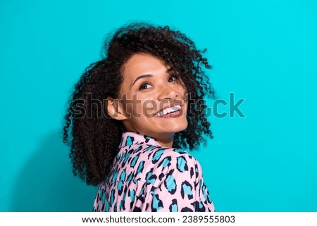 Photo of positive cheerful girl wear trendy clothes curly hairstyle look up empty space salon procedure isolated on cyan color background