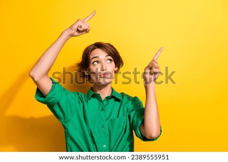 Photo of doubtful suspicious lady wear green shirt looking showing two fingers empty space isolated yellow color background Royalty-Free Stock Photo #2389555951