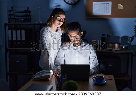 Man and woman business workers using laptop working at office