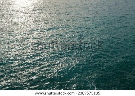 The sea with low gentle waves and a sunny path