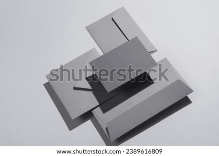 Floating gray envelopes on gray background with shadow. Minimalism, modern business still life, creative layout
