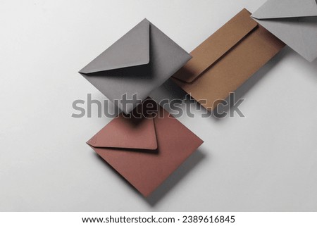 Floating envelopes on gray background with shadow. Minimalism, modern business still life, creative layout