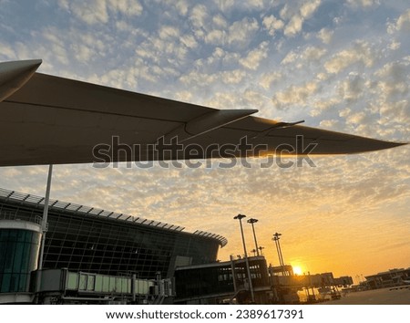 A large passenger jet pictured on the tarmac of an airport at sunset