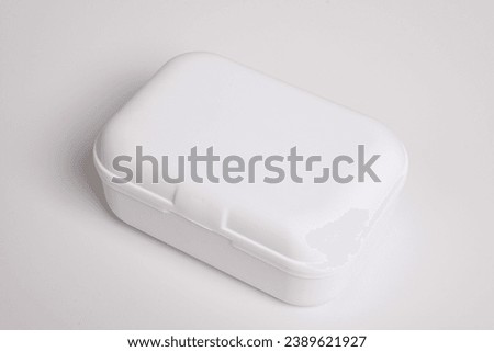 White small plastic box isolated on white background. Small case for minimal protection, closed Royalty-Free Stock Photo #2389621927
