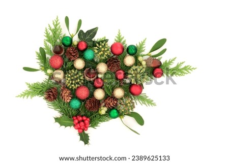 Christmas winter flora display with red, gold and green ball decorations. Traditional nature display for the holiday season, Yule, Noel, New Year on white.