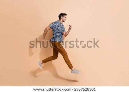 Side photo full length cadre of running marathon sportive young guy wearing casual outfit hurry up isolated on beige color background