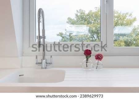 A farmhouse sink in a charming kitchen setting. This high quality stock photo captures the essence of traditional design, blending functionality and style seamlessly.