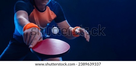Table tennis player in action close-up photo. Ping pong horizontal banner. Download a photo of a table tennis player for a tenis racket packaging design. Image for tennis ball box template. Royalty-Free Stock Photo #2389639337