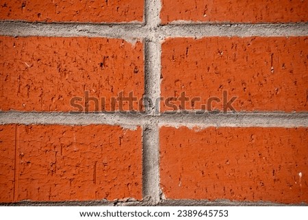 A striking photo captures the warm and inviting texture of an orange bricks background, creating a visually appealing display of earthy tones and architectural charm.