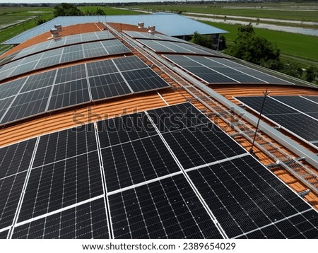 Top aerial view of solar roof system at the rooftop of factory warehouse. renewable energy of photovoltaic for reduce energy and carbon footprint. clean energy. solar panel and structure at building.
