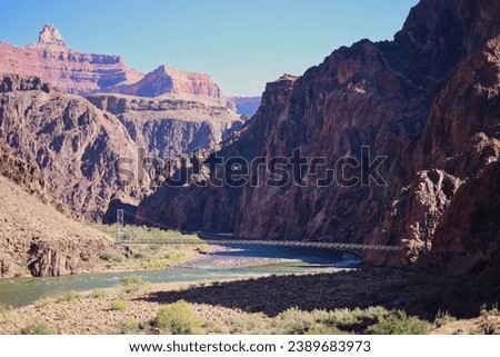 The silver bridge at the bottom of the Grand Canyon connects the Bright Angel Trail with the North Kaibiab Trail.  Royalty-Free Stock Photo #2389683973