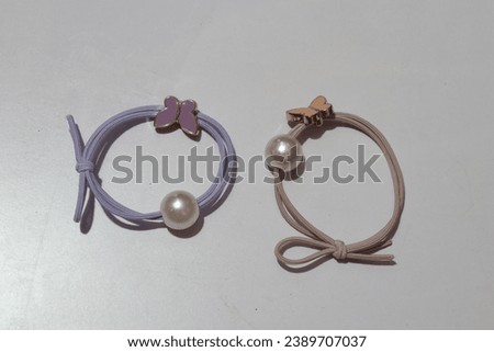 Pink and Lavender Colors Rubber Bands on a White Background