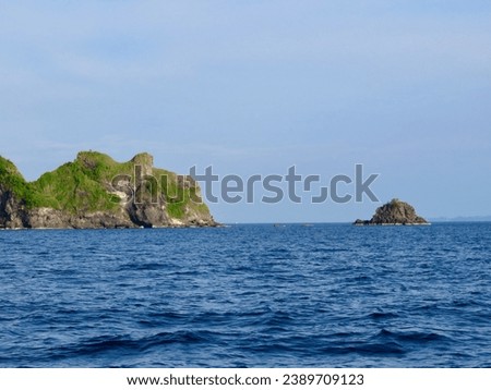 Rocky islands in the open sea. Small stone islands on the sea horizon in the middle of the ocean.                               
