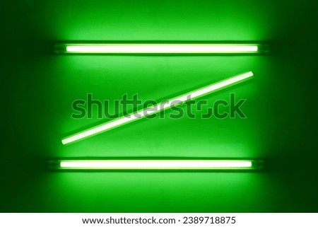 green neon bulbs on white wall. Background texture of empty old wall with glowing green neon bulbs.	