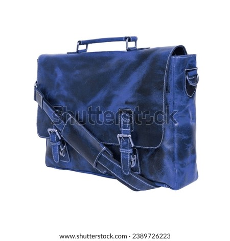 Blue leather briefcase bag, postman style. Handmade blue bag with strap to hang on the shoulder or hold the object with the hand. Type suitcase, haversack or satchel, isolated on white background Royalty-Free Stock Photo #2389726223