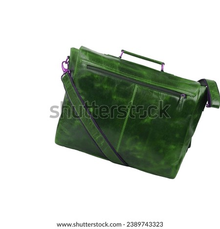 Green leather briefcase bag, postman style. Handmade green bag with strap to hang on the shoulder or hold the object with the hand. Type suitcase, haversack or satchel, isolated on white background Royalty-Free Stock Photo #2389743323