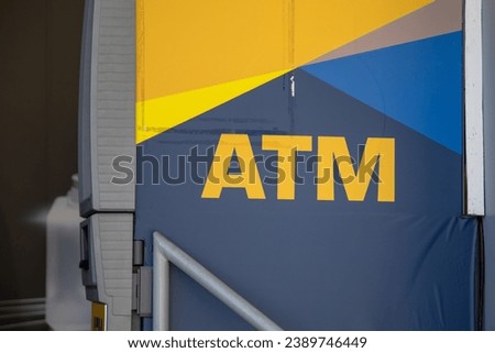 ATM text sign outside wall facade bank agency