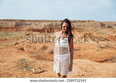 Portrait of beautiful tanned brunette woman outdoors