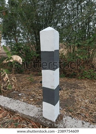 Road marking poles. Road markings are black and white