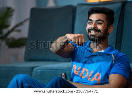 excited Young man Celebrating Indian cricket team victory while watching on tv at home - concept of Winning Happiness, Emotional moments and entertainment.