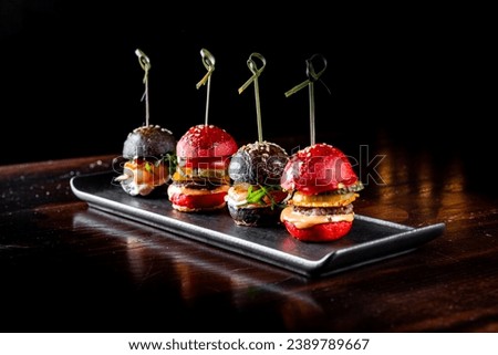 set mini hamburgers, mini burgers on plate Royalty-Free Stock Photo #2389789667