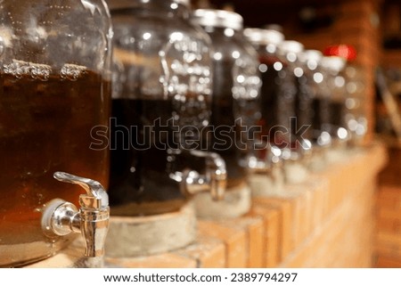 full containers of homemade wine in the storage