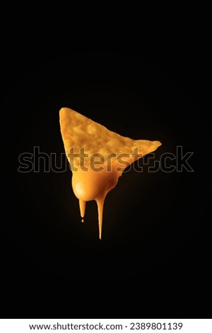 Nacho chips dripping with cheddar cheese Royalty-Free Stock Photo #2389801139