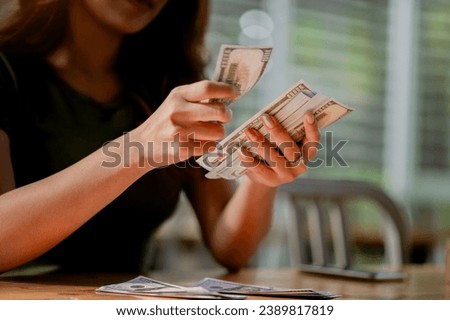 dollar currency Asian girl counting money, salary, income from financial investments, cash flow, shopping and payments.