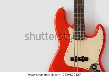 Red bass guitar on white background. Music wallpaper