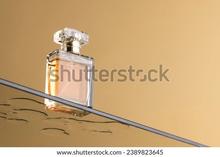 Beauty product perfume bottle on glass shelf with copy space on orange background. Health and beauty, make up and beauty concept.