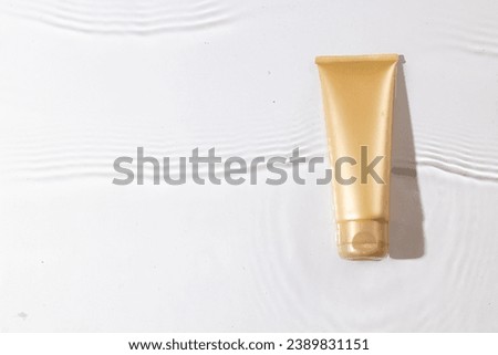 Beauty product tube in water with copy space background on white background. Health and beauty, make up and beauty concept.