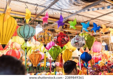 Colorful decorated lanterns hang on the streets in Ho Chi Minh City, Vietnam during the Mid-Autumn Festival. The Chinese in the picture means money and happiness. Selective focus.