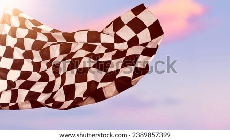 Checkered Racing Flag against Sunset Sky. Dramatic Background with Racing Sign.