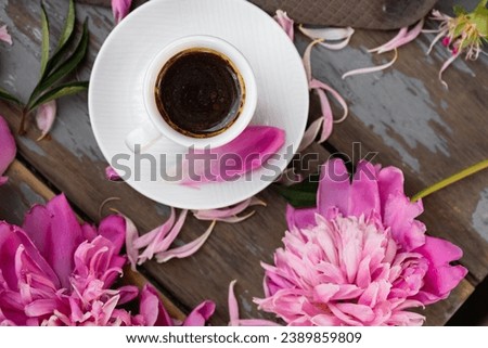 Pink peony flowers and a cup of coffee on a white background. Morninig, spring, fashion composition. Flat lay, top view, copy space.