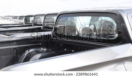 new grey SUV PICKUP vehicle, back view. Photography of a many, a lot modern pickup. made in Japan. parking in long perspective. back, rear view.  Royalty-Free Stock Photo #2389861641