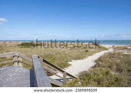 A pathway leads towards the Atlantic Ocean at Lori Wilson Park (Cocoa Beach), Florida. Royalty-Free Stock Photo #2389898509