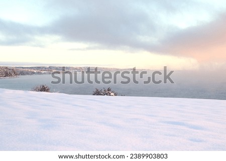 Beautiful pictures of lake, fog and snow. Fog and sunset. Winter weather.