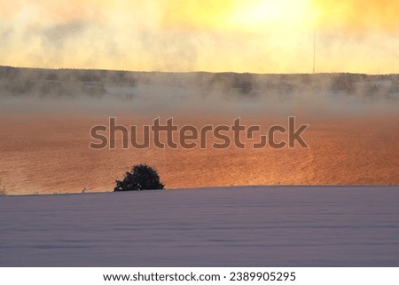 Beautiful pictures of lake, fog and snow. Fog and sunset. Winter weather.