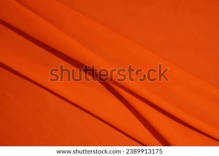 Wrinkled Orange Fabric Texture Background