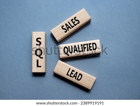 SQL - Sales Qualified Lead. Wooden cubes with words SQL. Beautiful grey background. Business and SQL concept. Copy space.