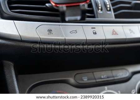 A car lock button and status light and emergency stop button in car interior