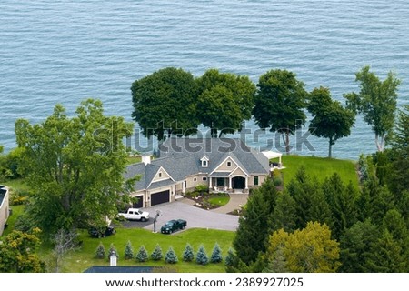 Upscale suburban home on lake Ontario waterfront area in Rochester, NY. Private residential houses in rural suburban sprawl in upstate New York Royalty-Free Stock Photo #2389927025