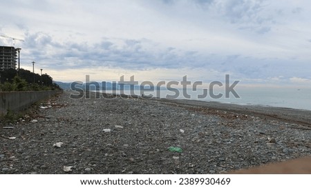Black sea beach in Kobuleti Georgia with stones and ocean with view of Batumi with rocks and pebbles