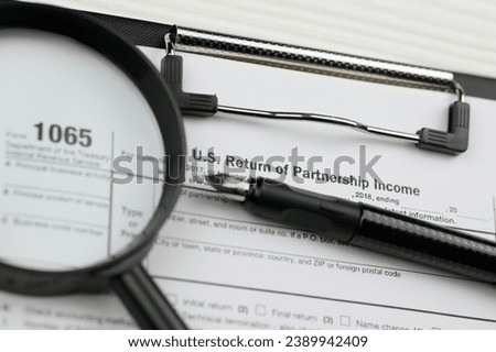 IRS Form 1065 US Return of Partnership Income blank on A4 tablet lies on office table with pen and magnifying glass close up Royalty-Free Stock Photo #2389942409
